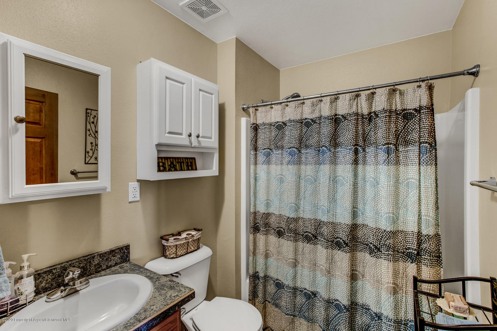 5101 County Road 233 Rifle, CO 81650 - Photo 17 of 26 a bathroom with a sink a toilet a mirror and shower