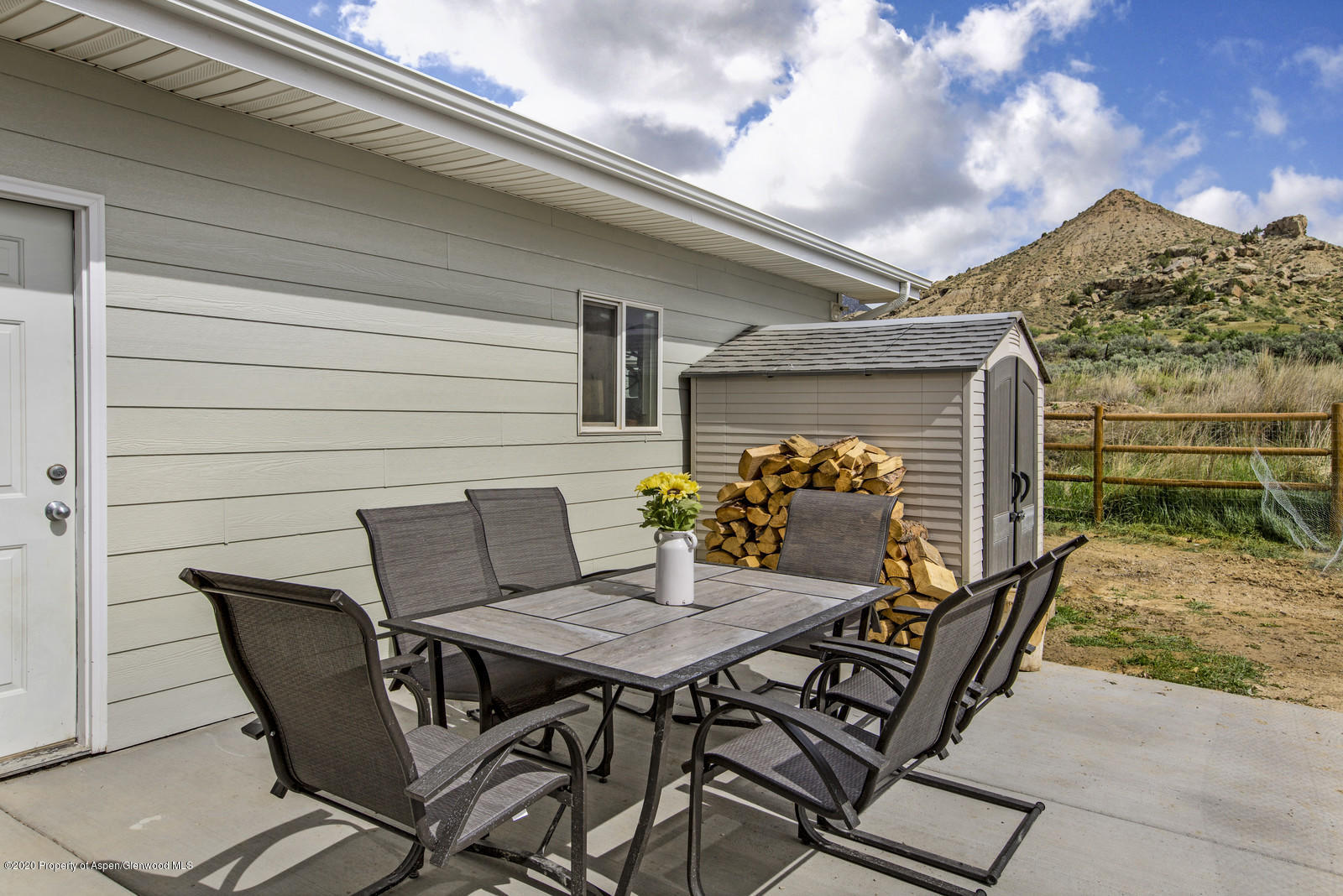 5101 County Road 233 Rifle, CO 81650 - Photo 20 of 26 a view of a patio with table and chairs with wooden floor and fence