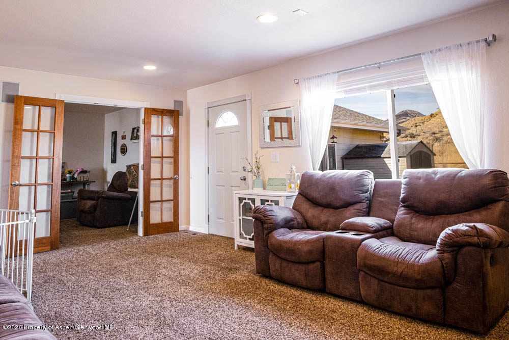 5101 County Road 233 Rifle, CO 81650 - Photo 5 of 26 a living room with furniture and a flat screen tv