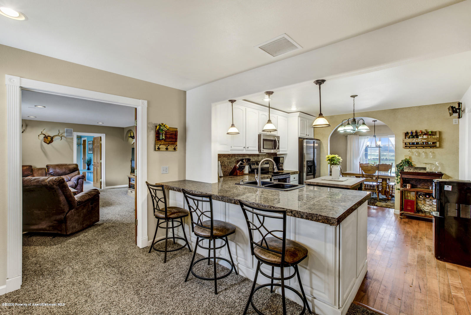5101 County Road 233 Rifle, CO 81650 - Photo 7 of 26 a kitchen with sink table and chairs