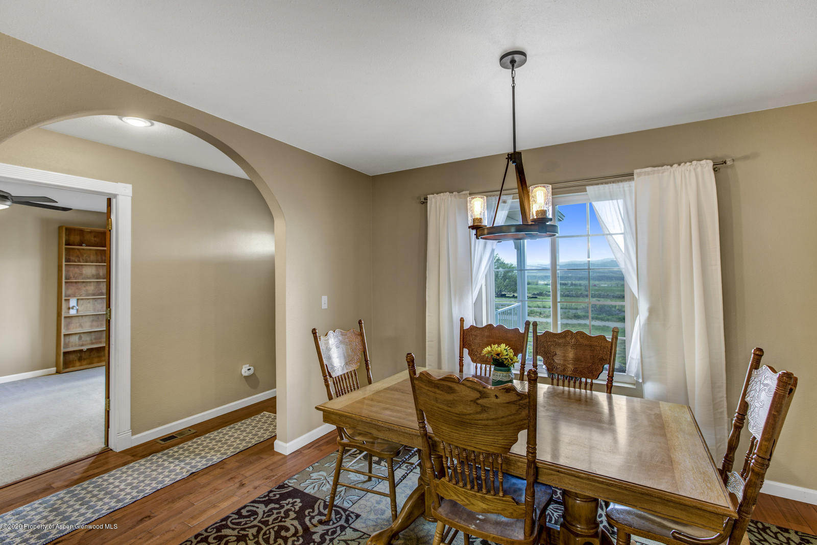5101 County Road 233 Rifle, CO 81650 - Photo 10 of 26 a dining room with furniture a chandelier and wooden floor
