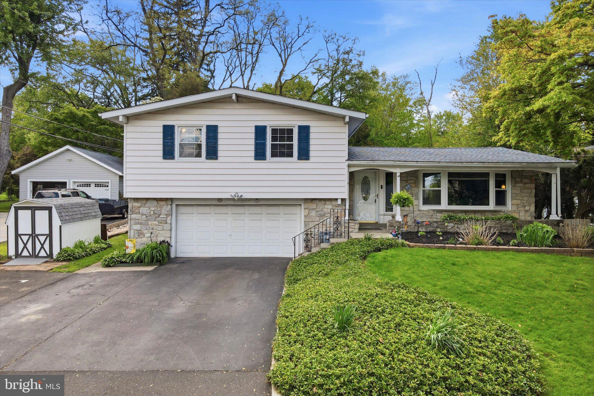 Charming split-level home with lush greenery.