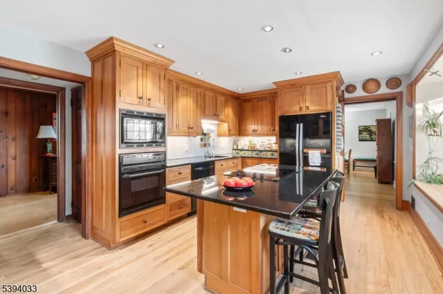 a kitchen with stainless steel appliances granite countertop a refrigerator and a stove top oven
