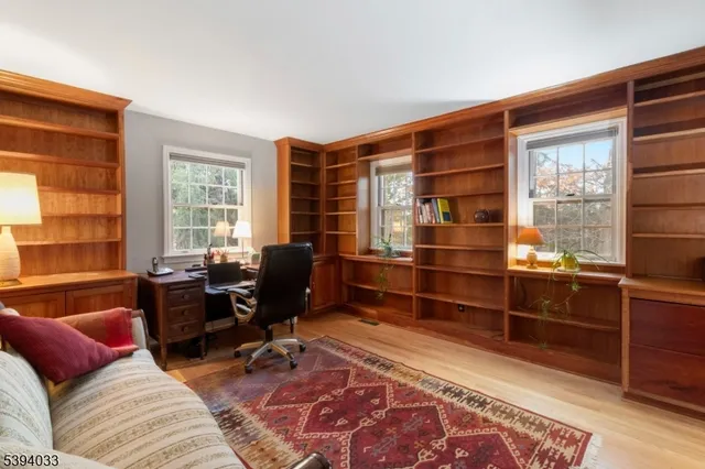 a livingroom with workspace and a window