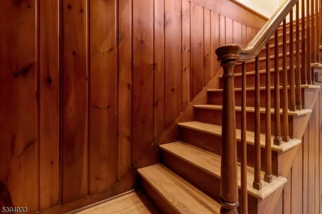 a living room with wooden floor furniture and a window