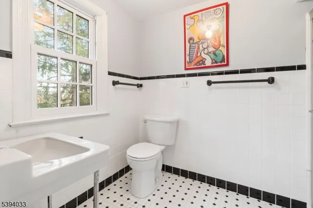 a bedroom with furniture and a large window