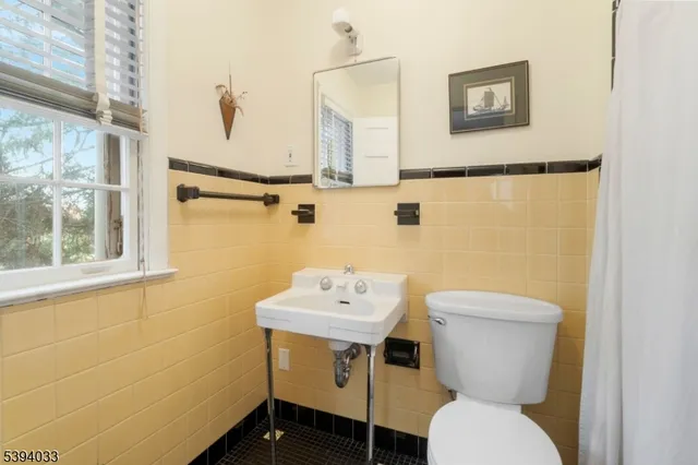 a living room with furniture a piano and a window