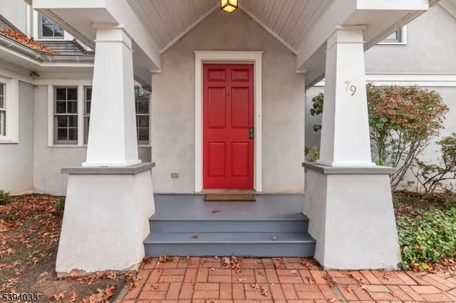 a front view of a house with white walls