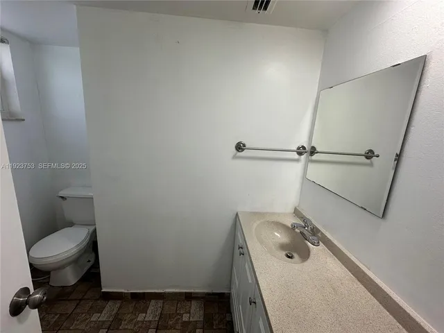 a bathroom with a sink a toilet and a shower
