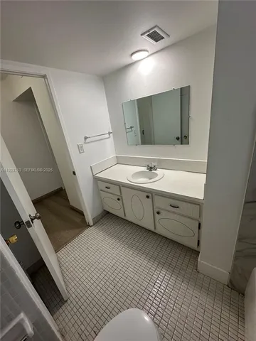 a bathroom with a double vanity sink a mirror and a bathtub