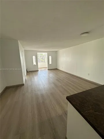 an empty room with wooden floor