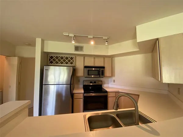 a kitchen with a refrigerator sink and stove