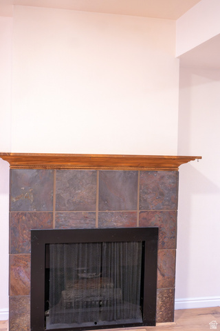 1269 North 400 East, Unit 3 Logan, UT 84341 - Photo 7 of 23 Fireplace featuring a wood mantel, stone tile surround, and a black metal firebox with a screen