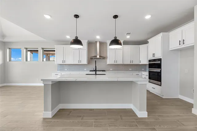a kitchen with kitchen island a sink stainless steel appliances and cabinets