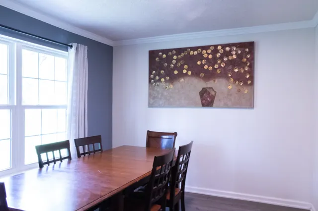 a view of a dining room with furniture and window
