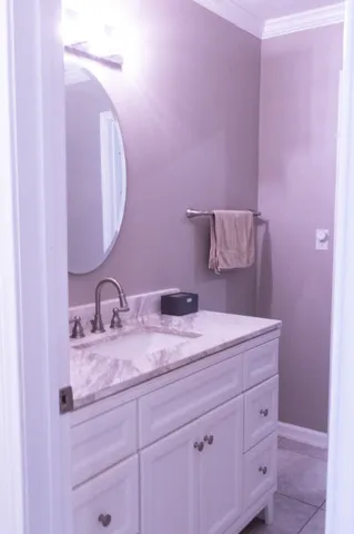 a bathroom with a granite countertop sink a mirror and vanity