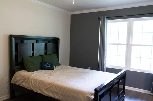 a bathroom with a granite countertop sink toilet and mirror