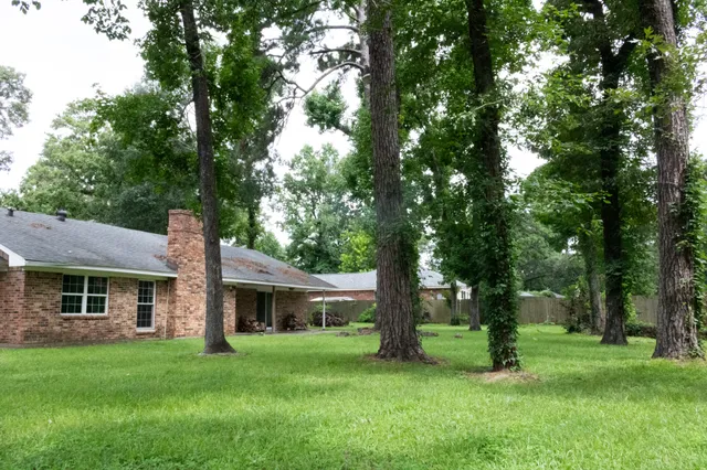 a front view of a house with a garden and patio