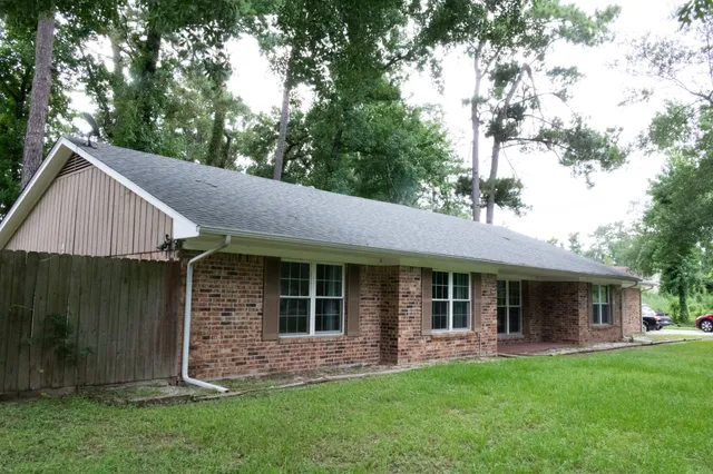 a front view of a house with a garden and porch