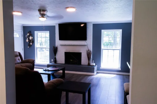 a living room with furniture fireplace and flat screen tv