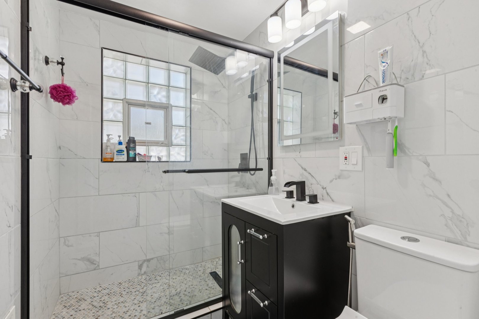 8846 Austin Avenue Morton Grove, IL 60053 - Photo 15 of 35 a bathroom with a sink vanity and a mirror