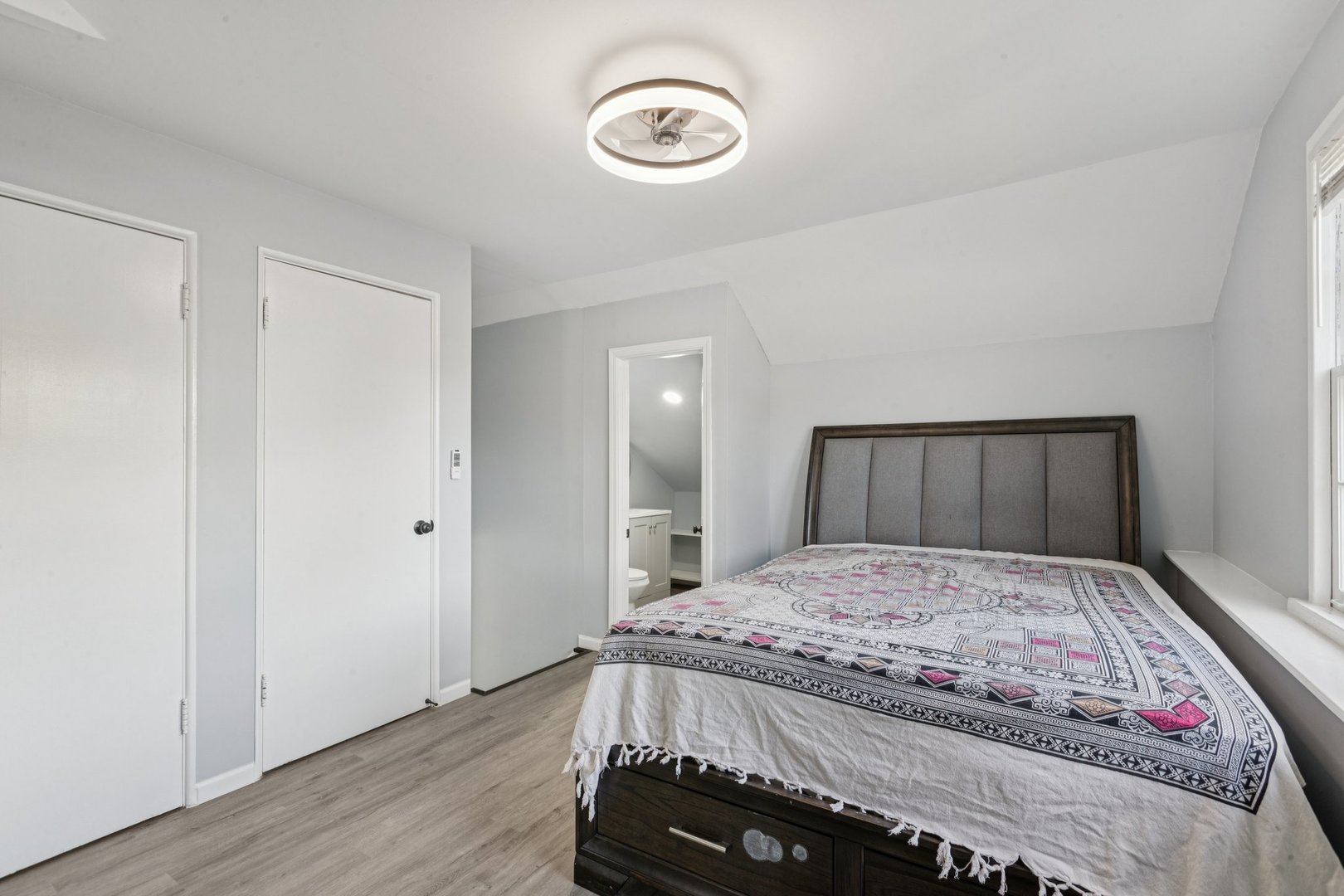 8846 Austin Avenue Morton Grove, IL 60053 - Photo 19 of 35 a bedroom with a large bed and a chandelier