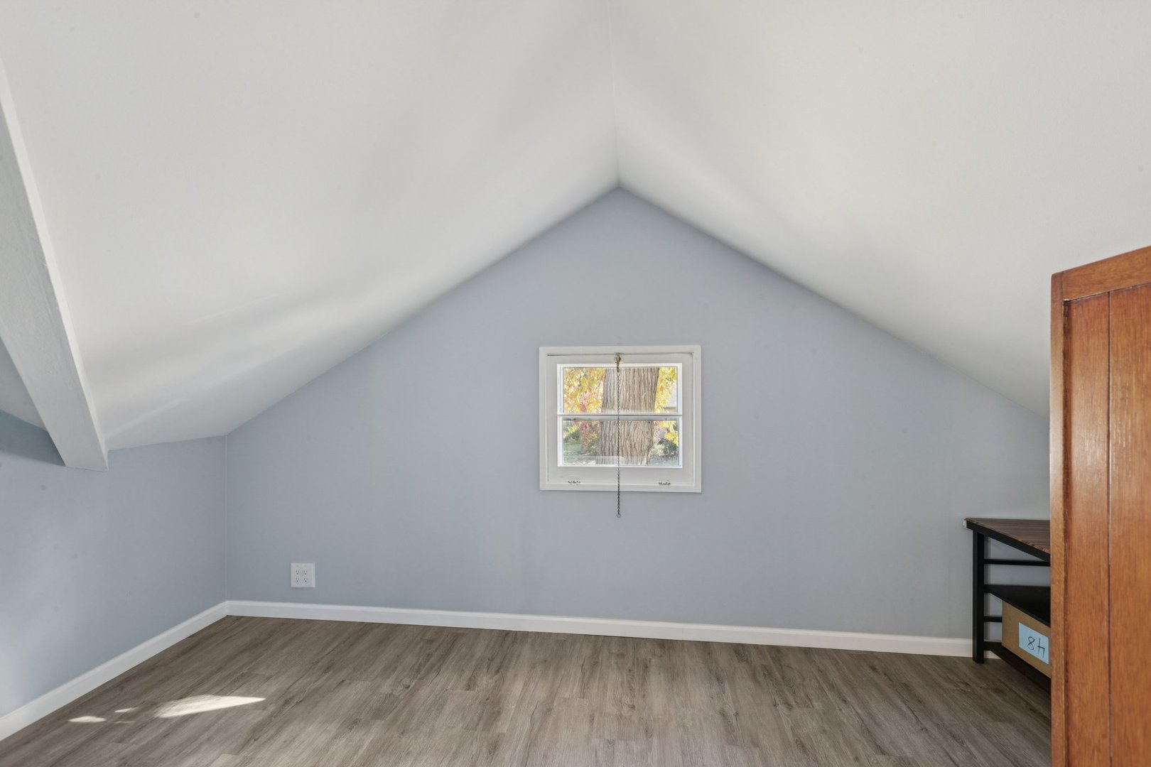 8846 Austin Avenue Morton Grove, IL 60053 - Photo 21 of 35 a view of an empty room with wooden floor and a window