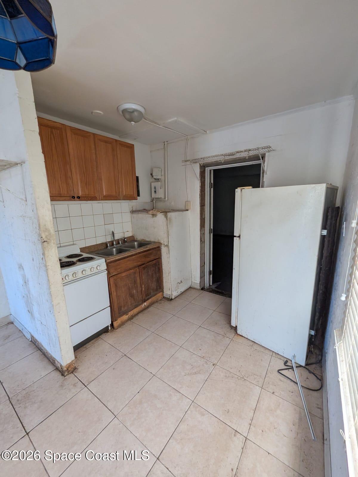 545 Easy Street Merritt Island, FL 32953 - Photo 4 of 9 a kitchen with a cabinets and white appliances