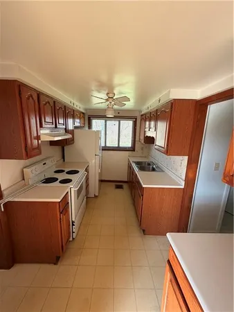 a kitchen with stainless steel appliances a stove a sink and a microwave