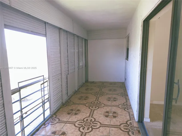 a utility room with a sink and a mirror