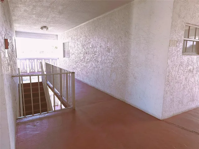 a view of empty room with floor to ceiling window