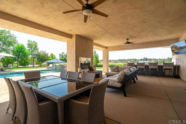 a outdoor dining space with furniture and city view
