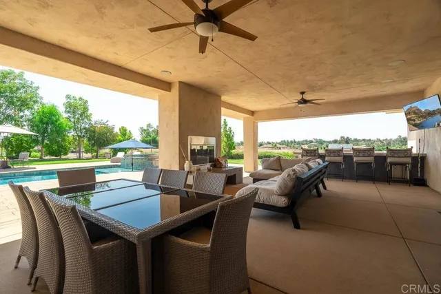 a outdoor dining space with furniture and city view