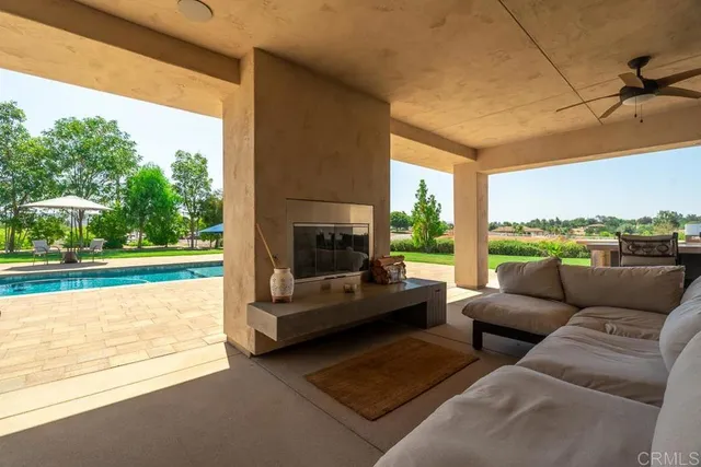 a living room with patio furniture and a large window