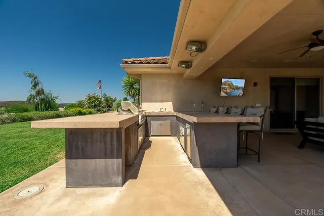 a large white kitchen with a stove and a sink