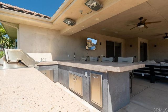 a large white kitchen with a stove and a sink
