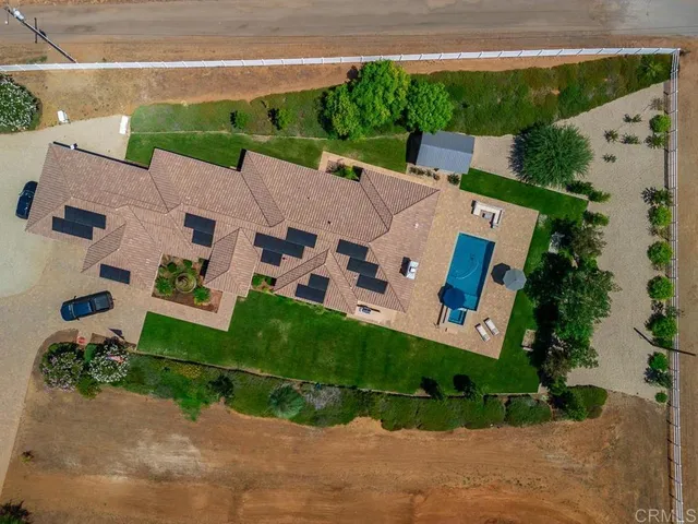 an aerial view of house with a yard