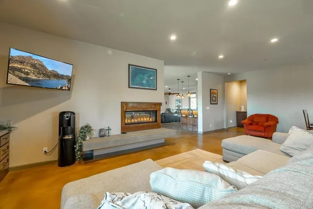 a dining room filled chandelier and kitchen view