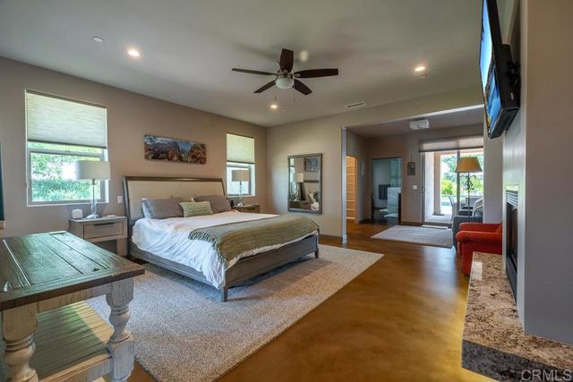a bedroom with a large bed and a chandelier