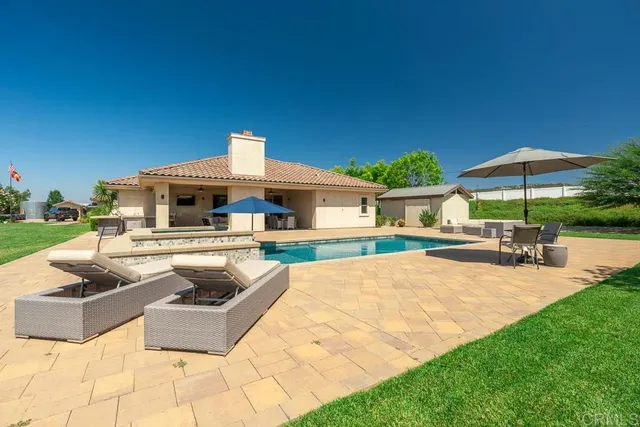 a view of a house with backyard porch and sitting area