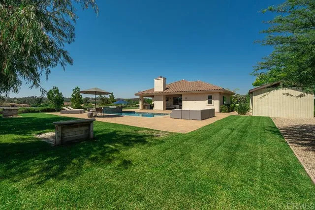 a front view of house with yard and outdoor seating