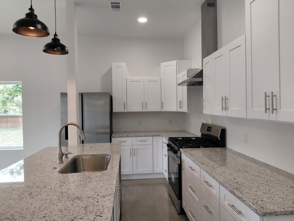 508 West Rainey Street Mason, TX 76856 - Photo 6 of 25 a kitchen with stainless steel appliances granite countertop a sink a stove and a granite counter tops