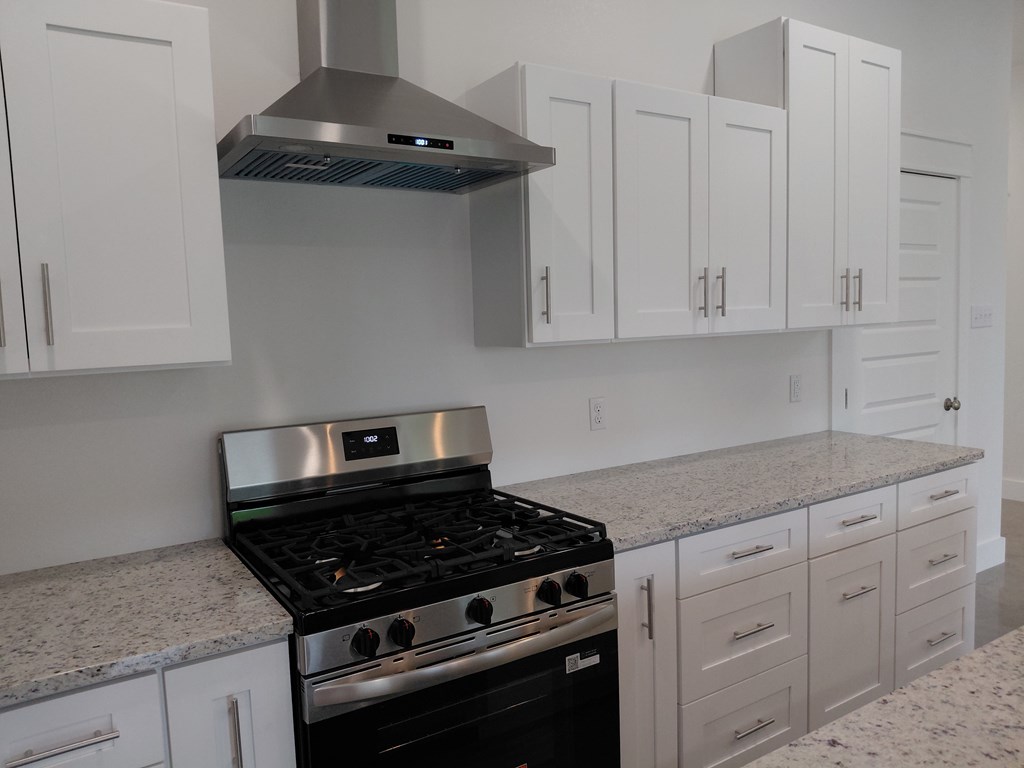 508 West Rainey Street Mason, TX 76856 - Photo 9 of 25 a kitchen with white cabinets and appliances