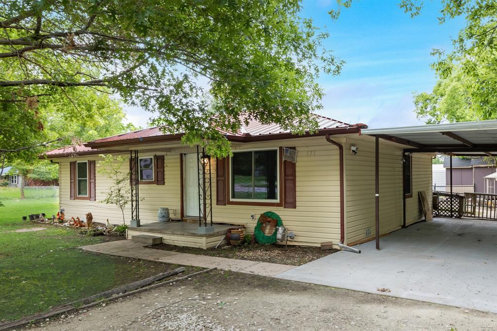 571 South 1st Street Point, TX 75472 - Photo 4 of 27 a front view of a house with garden