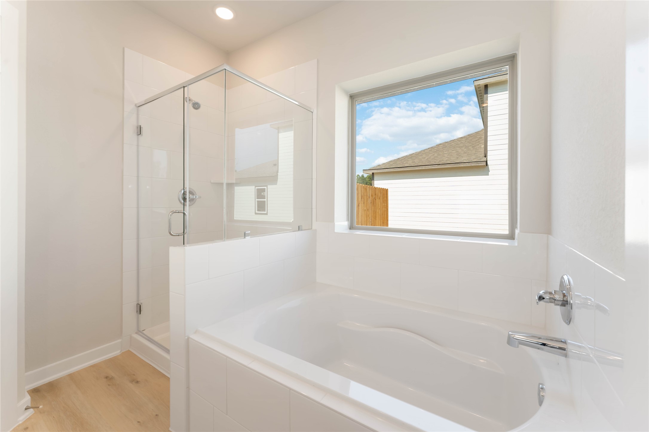 25992 Liberation Road Cleveland, TX 77328 - Photo 15 of 27 a bathroom with a bathtub and a shower