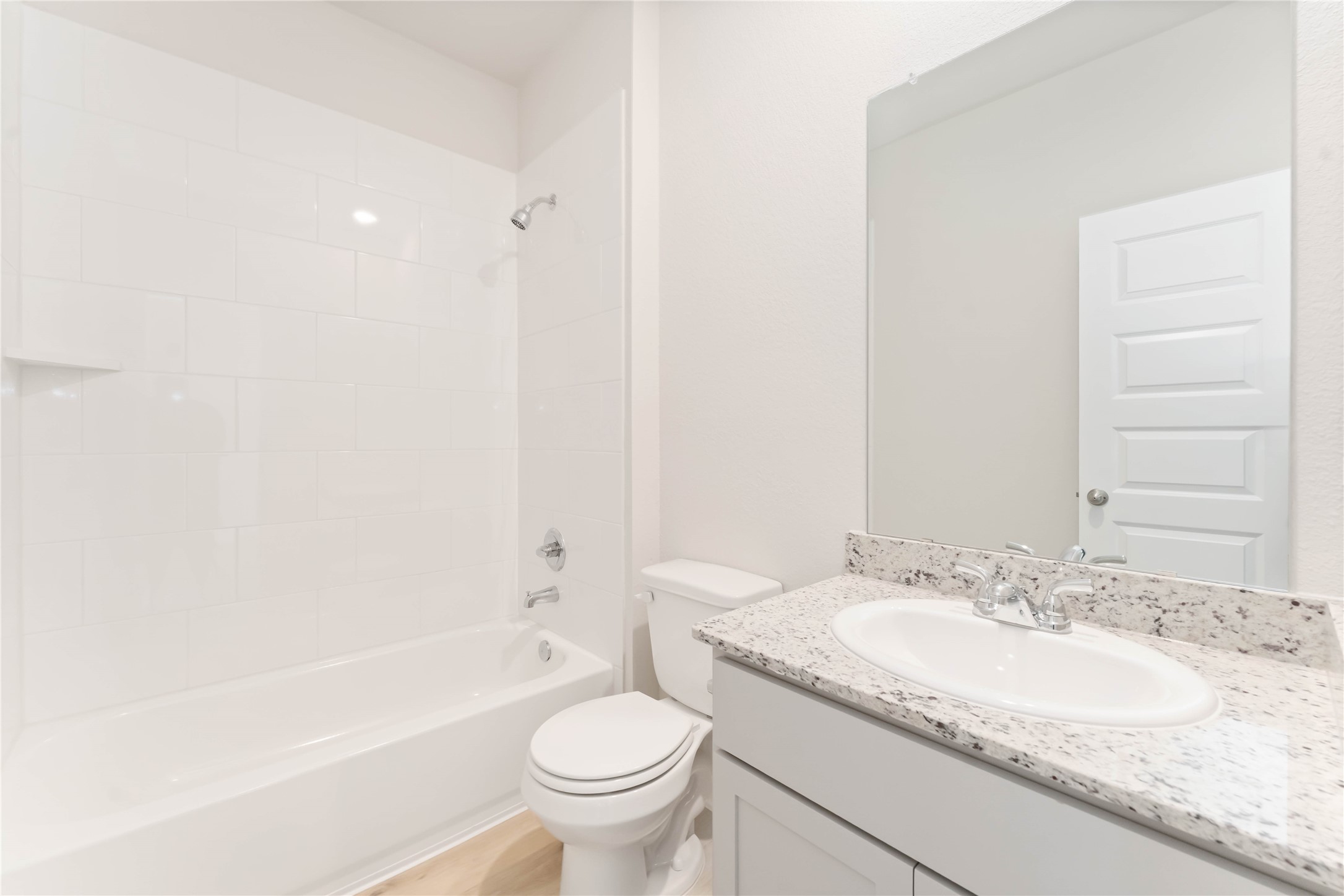 25992 Liberation Road Cleveland, TX 77328 - Photo 4 of 27 a bathroom with a granite countertop sink toilet and shower