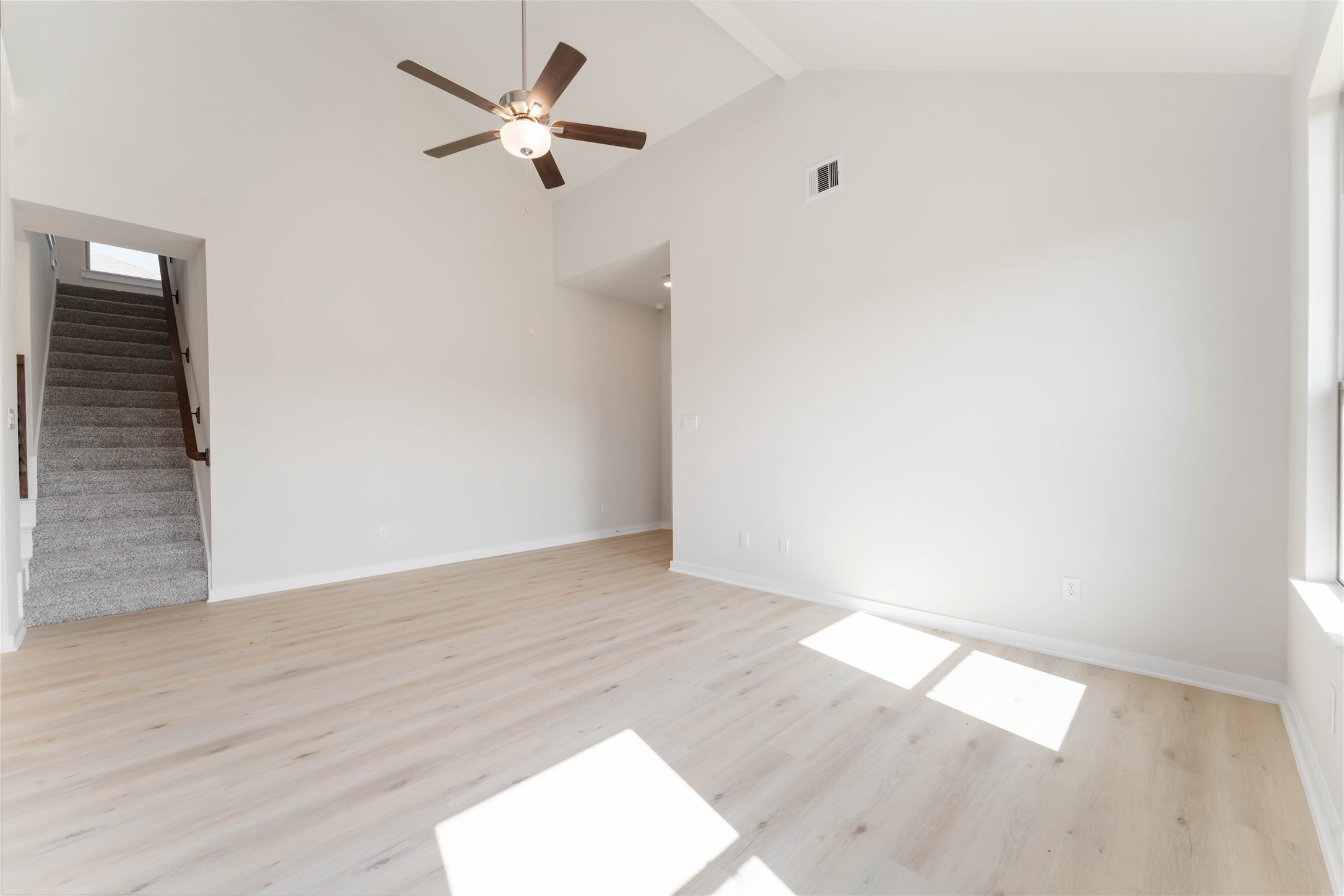 25992 Liberation Road Cleveland, TX 77328 - Photo 6 of 27 an empty room with wooden floor and fan