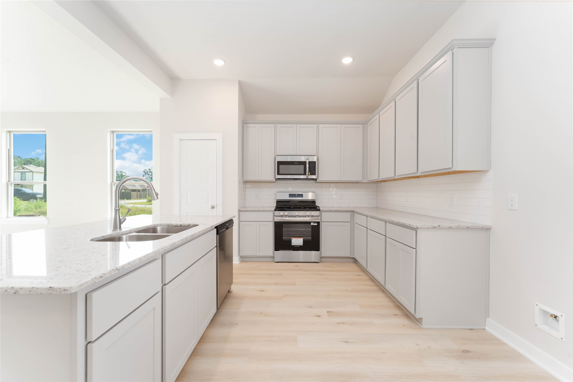 25992 Liberation Road Cleveland, TX 77328 - Photo 9 of 27 a large kitchen with stainless steel appliances granite countertop a stove and a sink