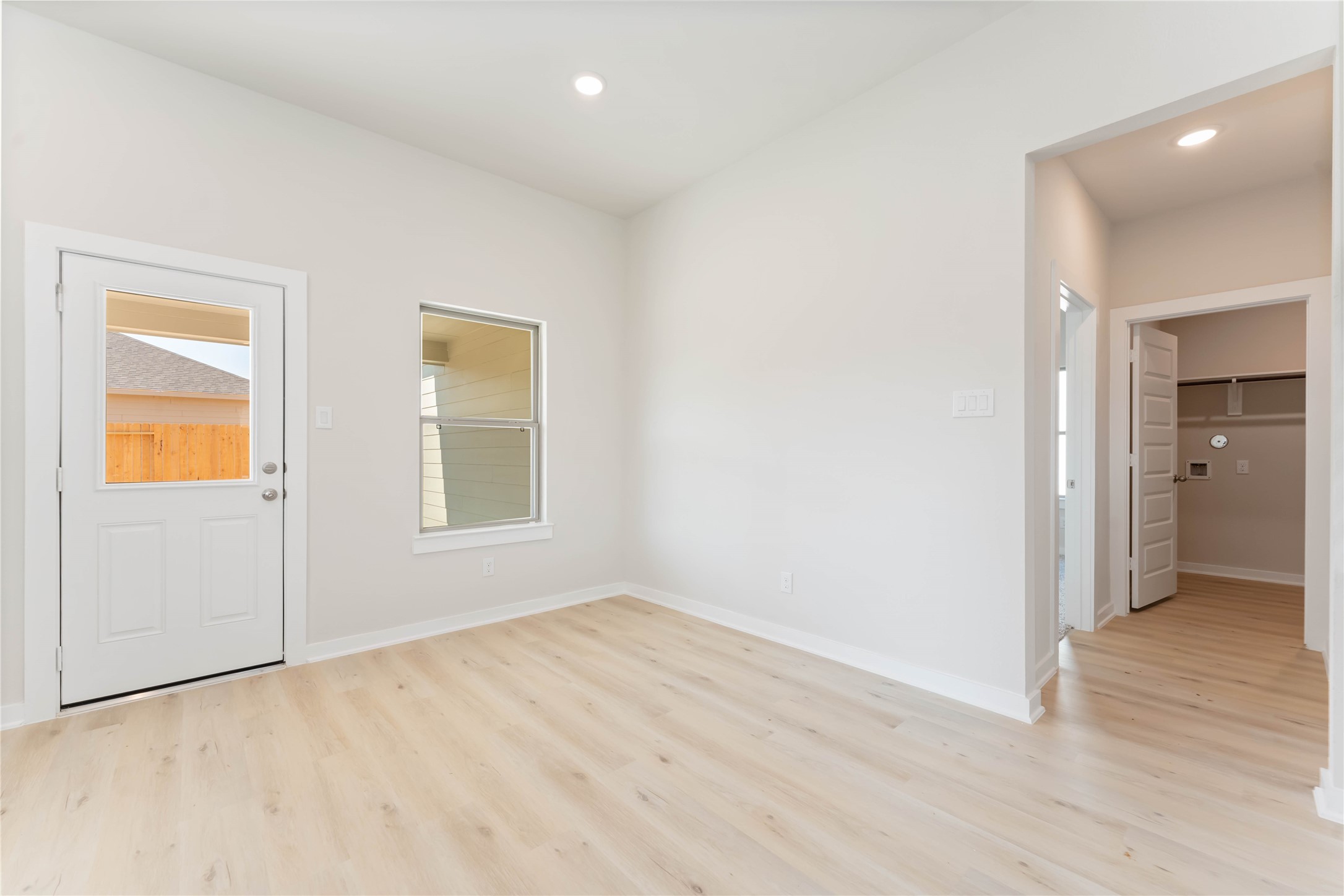25992 Liberation Road Cleveland, TX 77328 - Photo 10 of 27 an empty room with wooden floor and windows