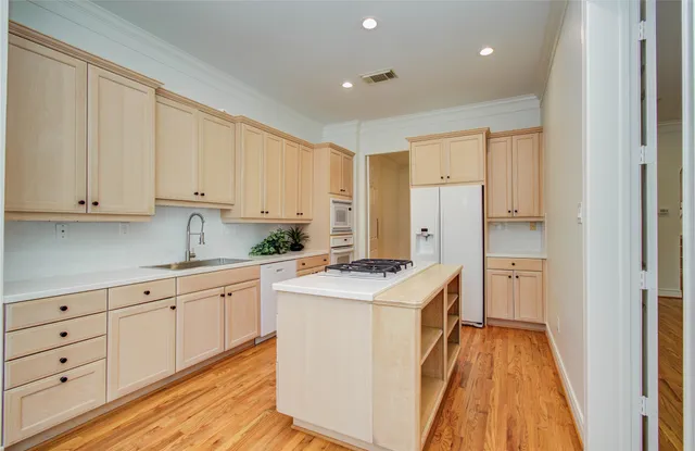 a view of a livingroom with wooden floor and a ceiling fan
